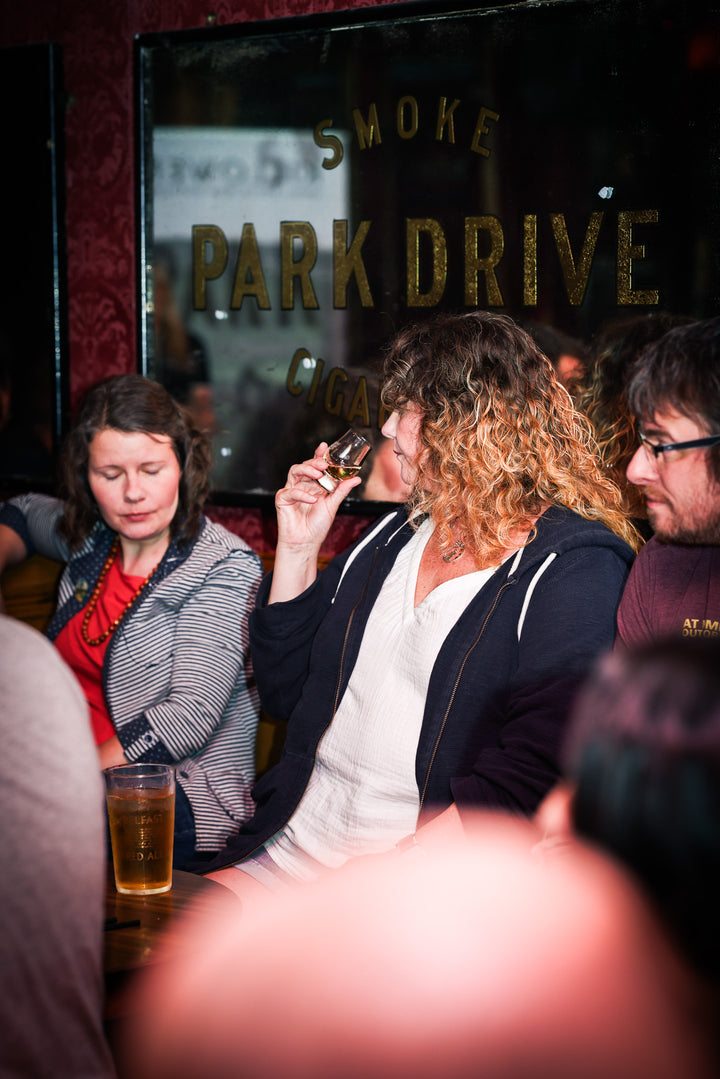 A guest noses a dram at a Belfast Whiskey Week whiskey tasting