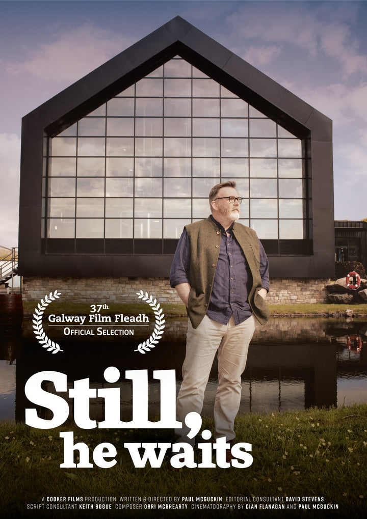 Still He Waits documentary poster featuring a man standing outside Ardara Distillery, an official selection at the 37th Galway Film Fleadh