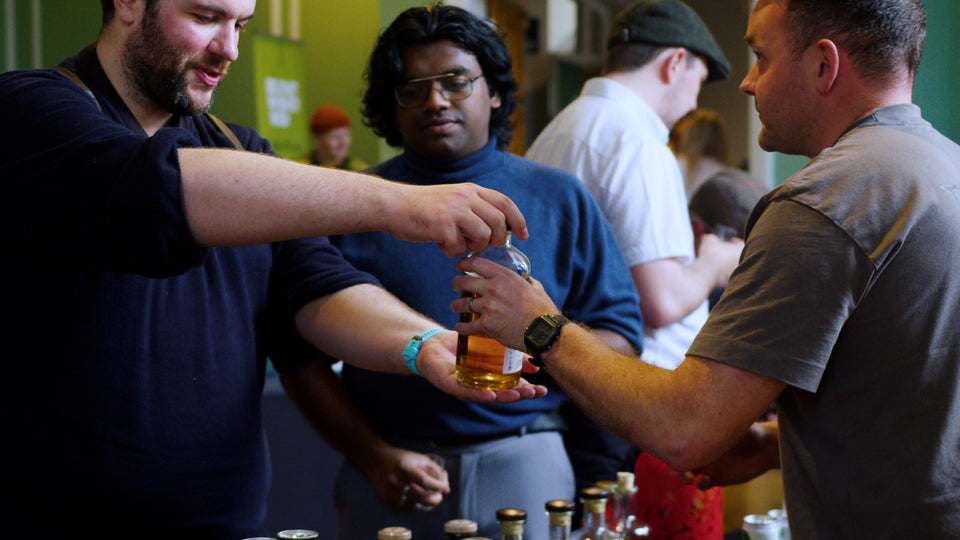 Two Stacks whiskey ambassador pouring a dram for festival-goers at Belfast Whiskey Week tasting