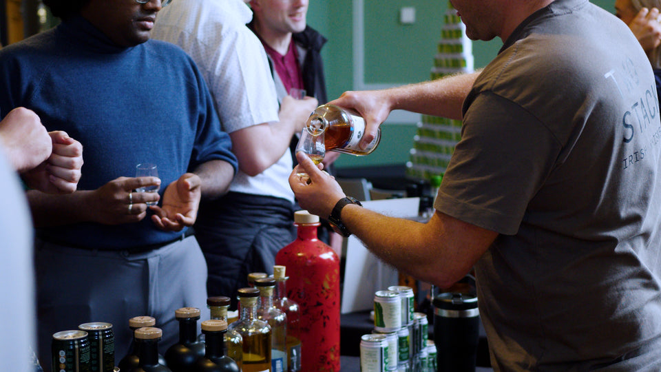Two Stacks Irish Whiskey ambassador pouring a dram for guests at a Belfast Whiskey Week festival tasting