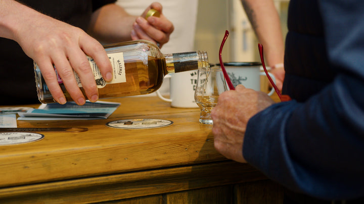 Malone's Irish whiskey being poured into a Glencairn tasting glass at a Belfast Whiskey Week whiskey tasting event