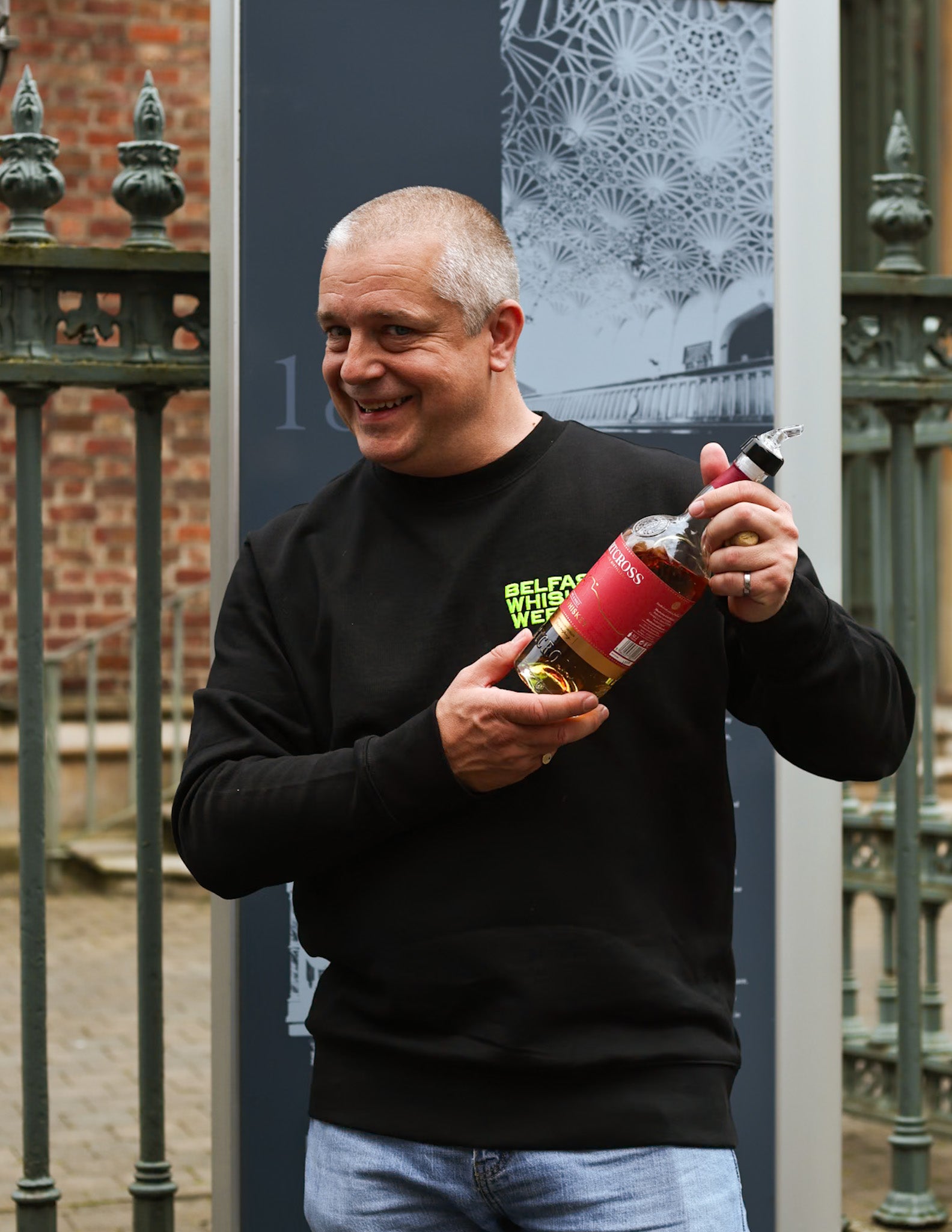 Marty holding a whiskey bottle during the tour
