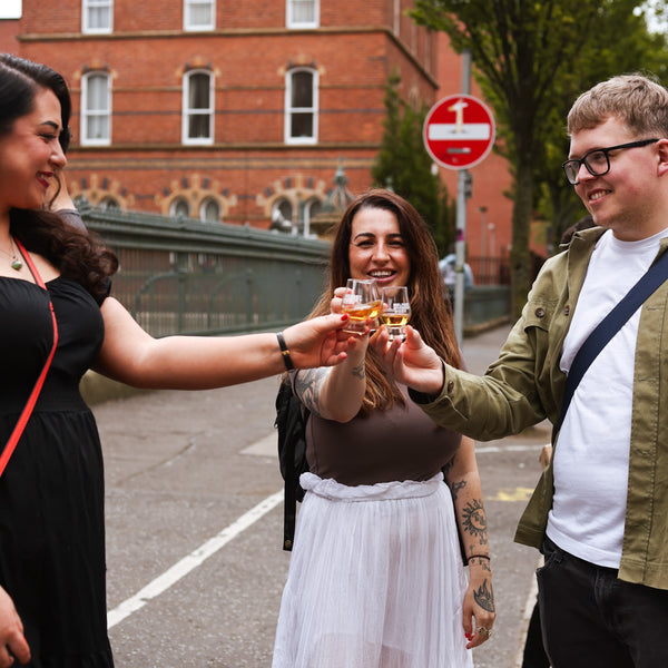 Three attendees clinking glasses in celebration, vibrant and joyful moment