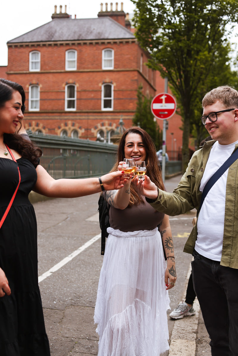 Three attendees clinking glasses in celebration, vibrant and joyful moment