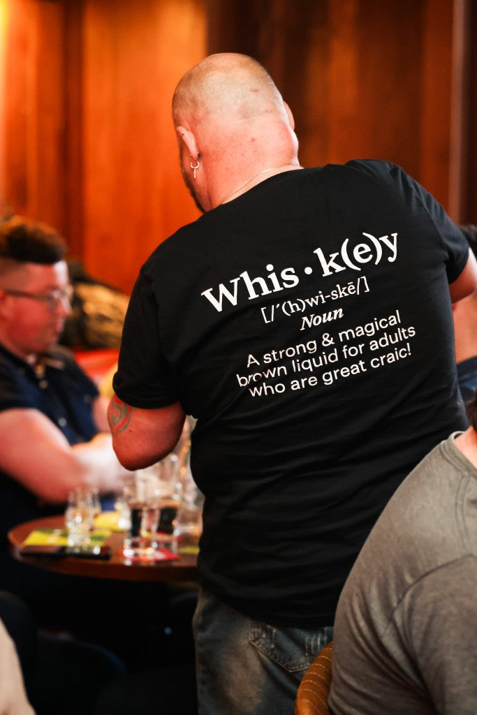 Guest wearing a humorous whiskey dictionary definition t-shirt at a Belfast Whiskey Week tasting