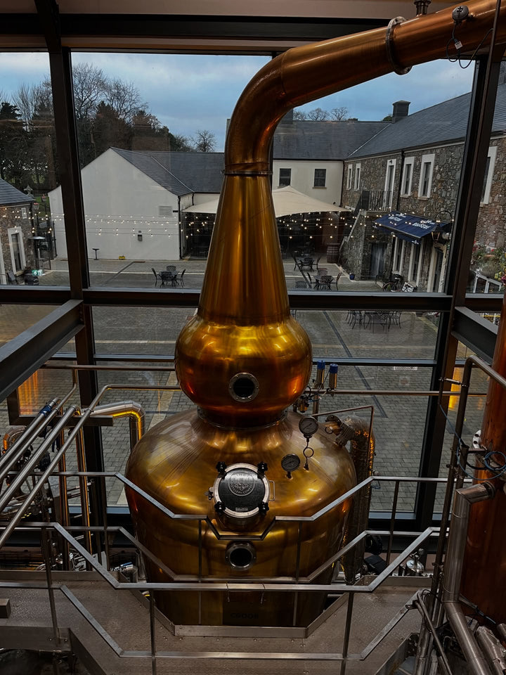 Copper pot still overlooking the courtyard at Hinch Distillery, Killaney Estate, County Down