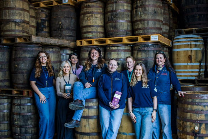 The Hinch Distillery team among casks in the maturation warehouse