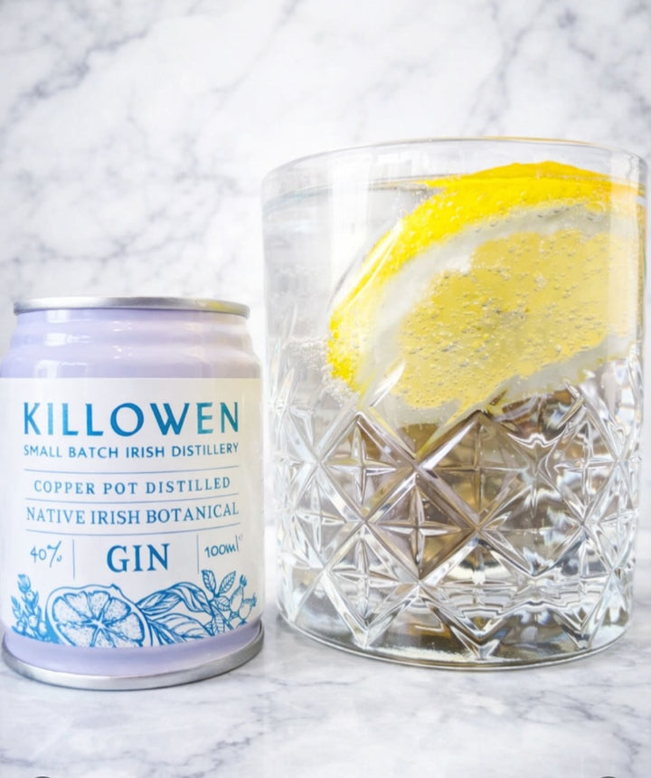 Killowen native Irish botanical gin can beside a gin and tonic with lemon