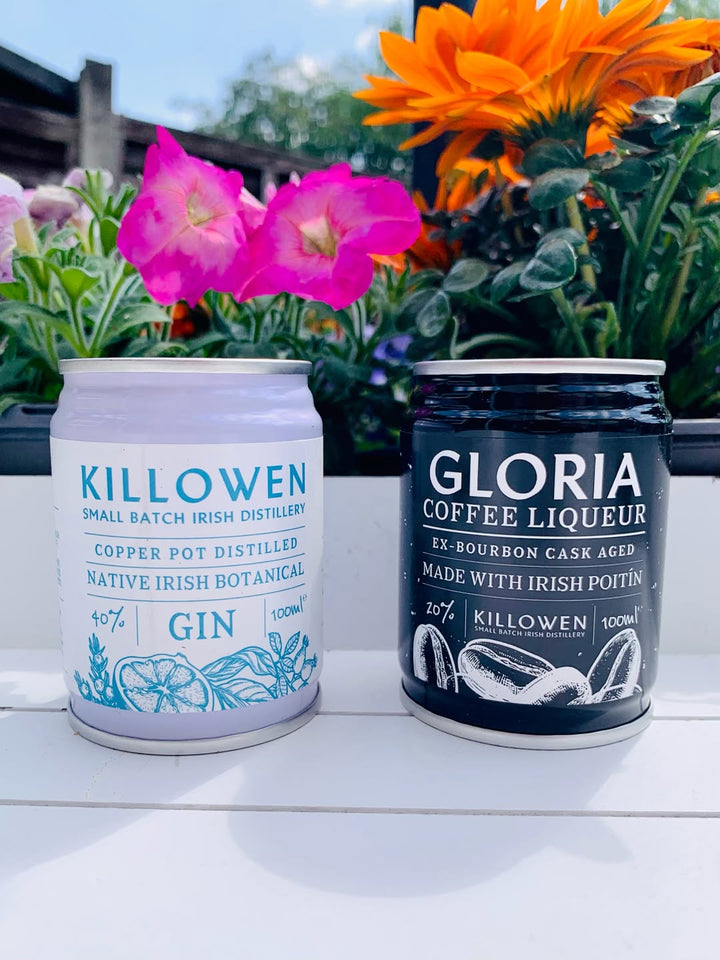 Killowen gin and Gloria coffee liqueur cans among summer flowers