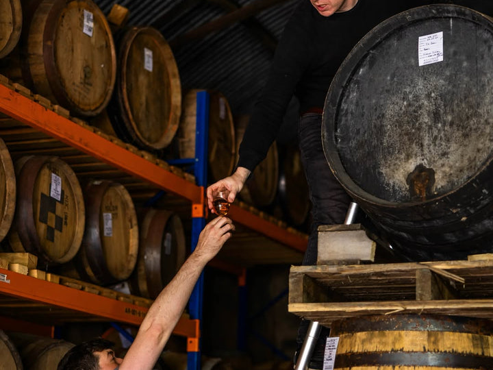 Passing a dram down from the racked casks in the Killowen Distillery warehouse