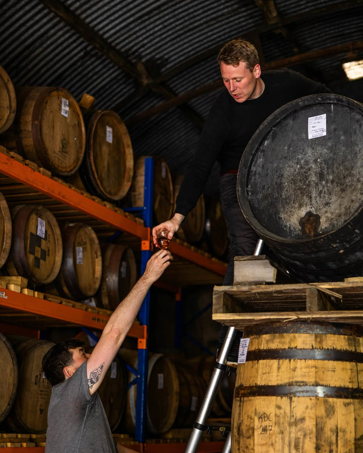 Passing a dram down from the racked casks in the Killowen Distillery warehouse